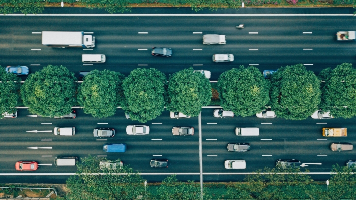 Aerial view of several cars driving on a motorway.