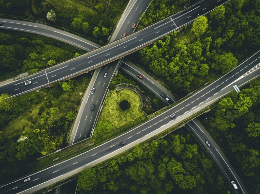 Aerial view of several cars driving on a motorway.